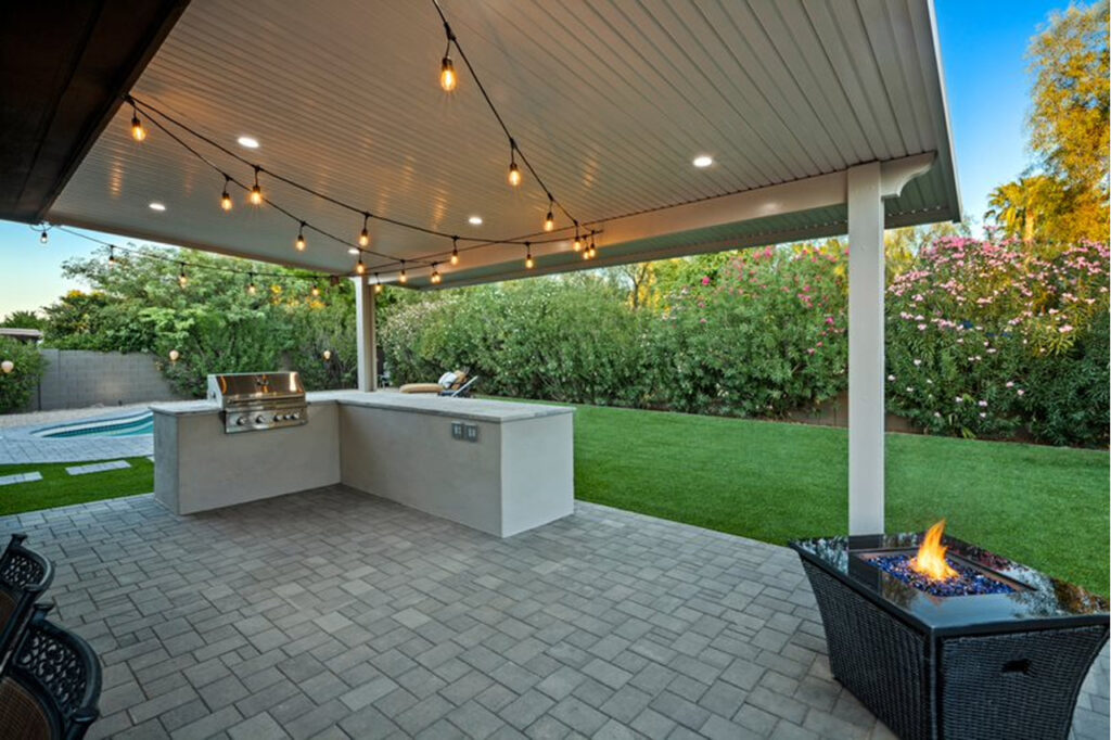 Backyard renovation with outdoor kitchen and synthetic turf in Arizona.